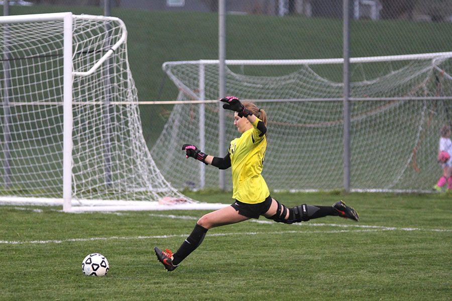 After Aquinas was called for an offsides penalty, senior goalkeeper Bailey Heffernon restarts the play from inside her own box.