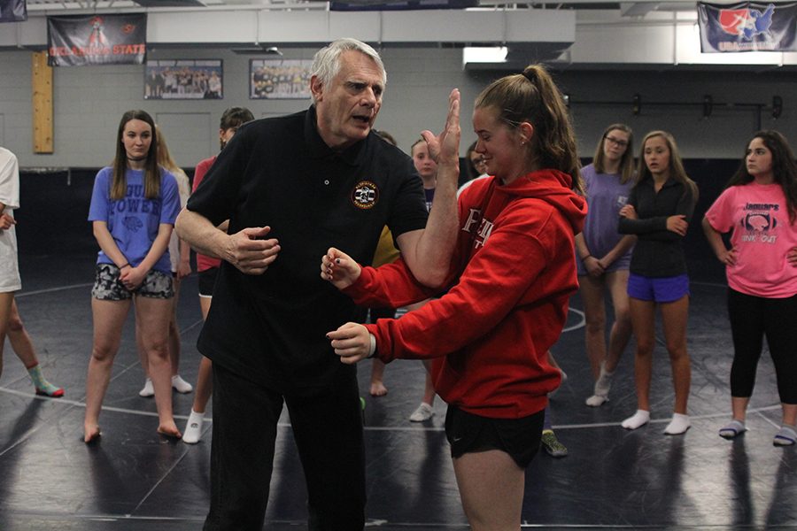 On+Friday%2C+April+13%2C+self-defense+instructor+Steven+Kinser+uses+freshman+Belle+Bonn+to+demonstrate+a+move+in+front+of+silver+fours+girls+PE+class.++