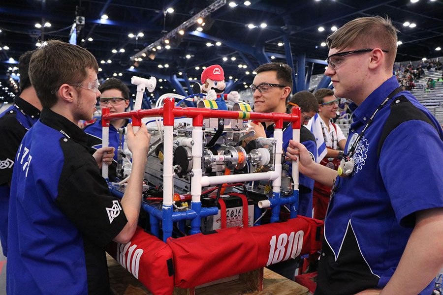 Getting ready for their next match, sophomore Jacob Howe and seniors Cody Moose and Zack Diebert from DHS, wait until the field is ready for setup.