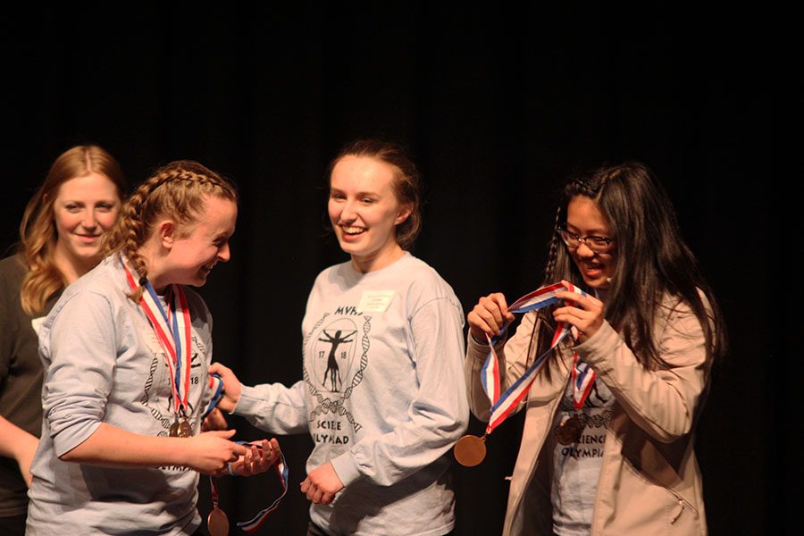 As they are recognized for third place in Experimental Design, freshman Hannah Chern and juniors Sydney Clarkin and Liz Fraka receive medals. 