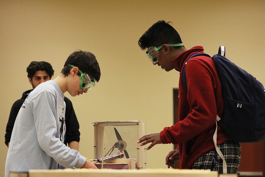 After the completion of the first hovercraft test trial, freshman Alex Whipple moves the battery to alter its path. 