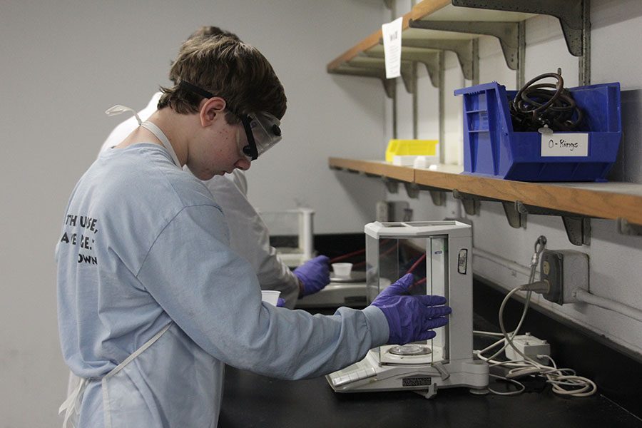 Measuring out a sample of magnesium, junior Andrew Thomas competes in Chemistry Lab. 