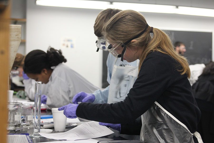 Running a test in a calorimeter, junior Aniston Cumbie touches the rim to gauge temperature.  