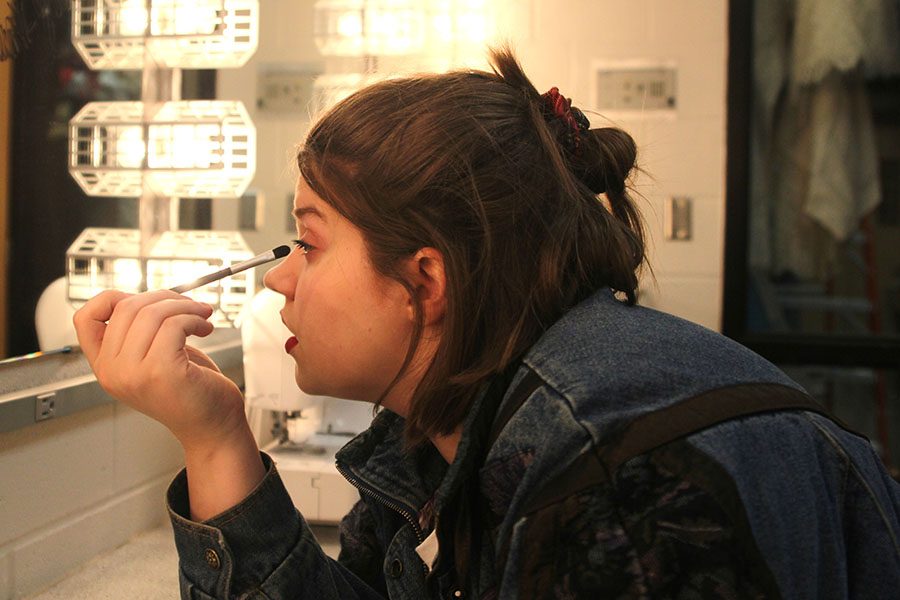 To save time in the mornings, junior Lindsey Edwards applies eyeshadow in class on Thursday, March 29. “I like to put on makeup because it is fun,” Lindsey said. “I think it’s interesting how you can look totally different with a bit of makeup.”