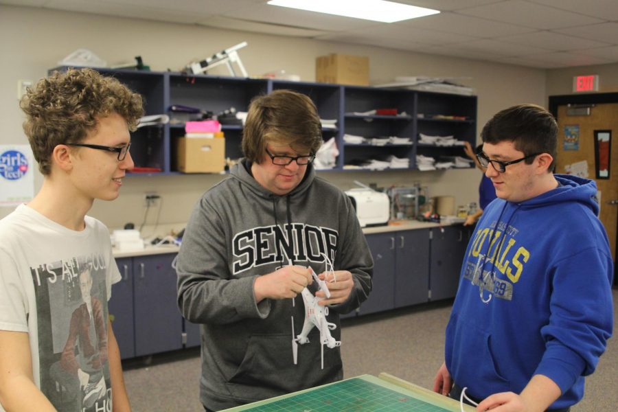 Adding wings to the drone, seniors Gage Weber, Hayden Shaw and Zach King carry parts to the body of the vessel on Sunday, April 8. JagFlight has multiple drones and sphere-os in use for practice.