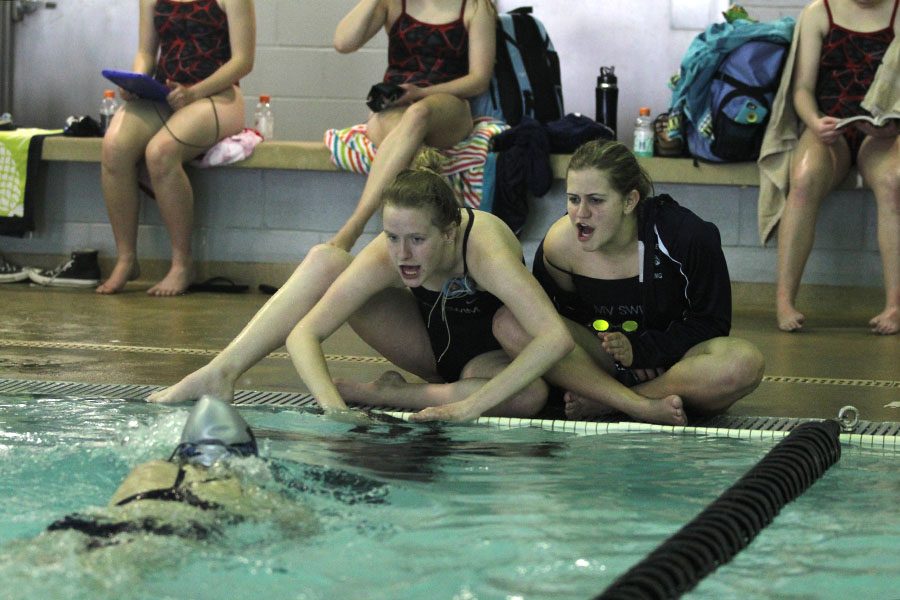 Sophomores Hannah Davie and Kayla Teasley, cheer on their teammate during the 500-yard freestyle.
