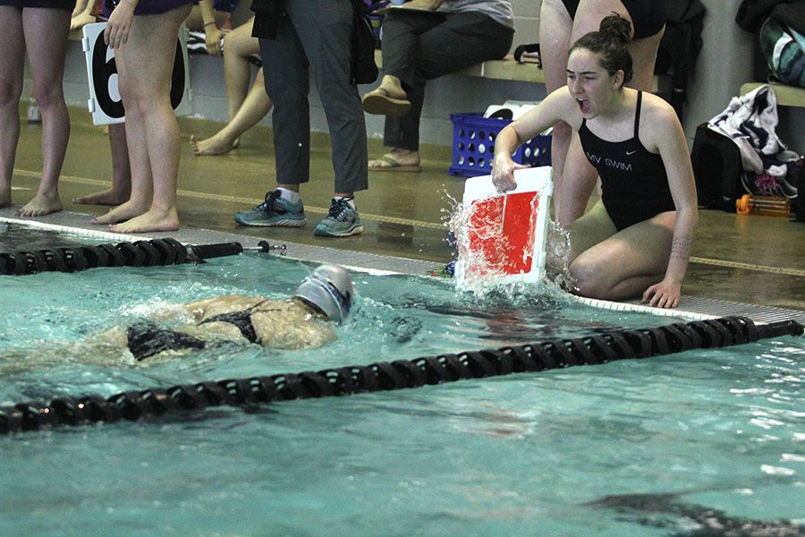 Freshman Grace McLeod counts laps for her teammate during the 500-yard freestyle. 