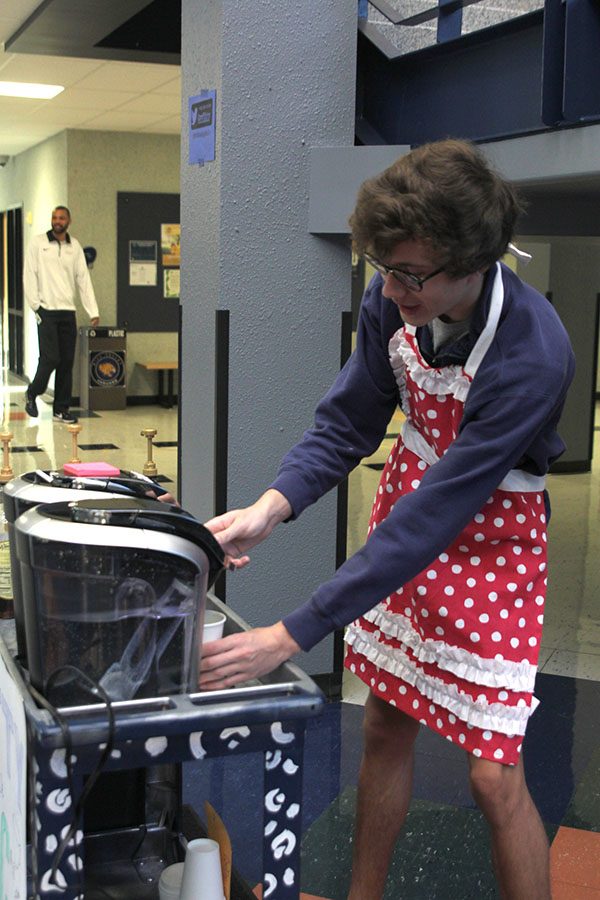 Pressing down on the Keurig coffeemaker, senior Brady Watkins sells coffee to teachers and students before school on Friday, April 15. I like getting to interact with people personally in the morning and making their day, Watkins said.