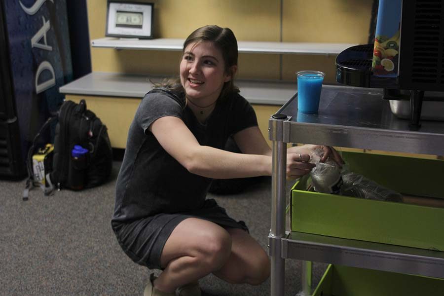 Working in the Catty Shack before school starts on Friday, April 13, senior Aly Tennis prepares a Fruit Blast frozen drink for a customer.