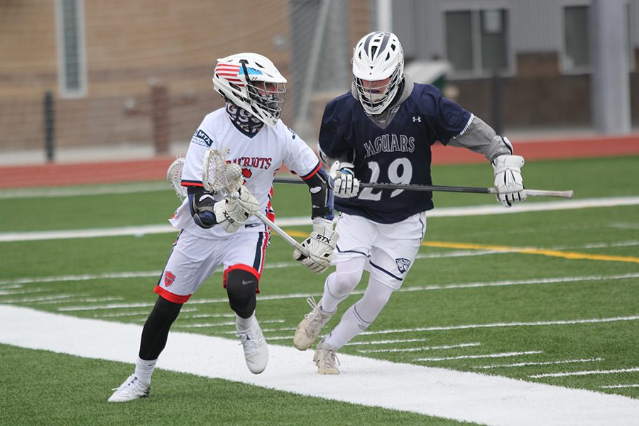 Running down the field, senior Camden Commerford keeps his eye on the ball.