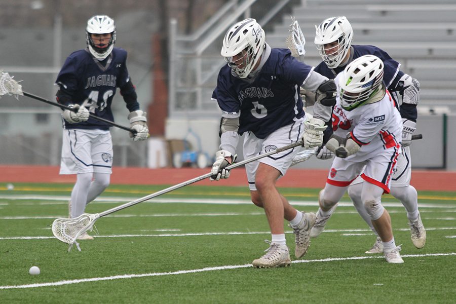 Extending the stick, senior Zac Janssen prepares to scoop up the ball.