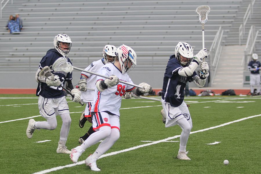 Sprinting towards the ball, sophomore Jameson Clark tries to beat his opponent.