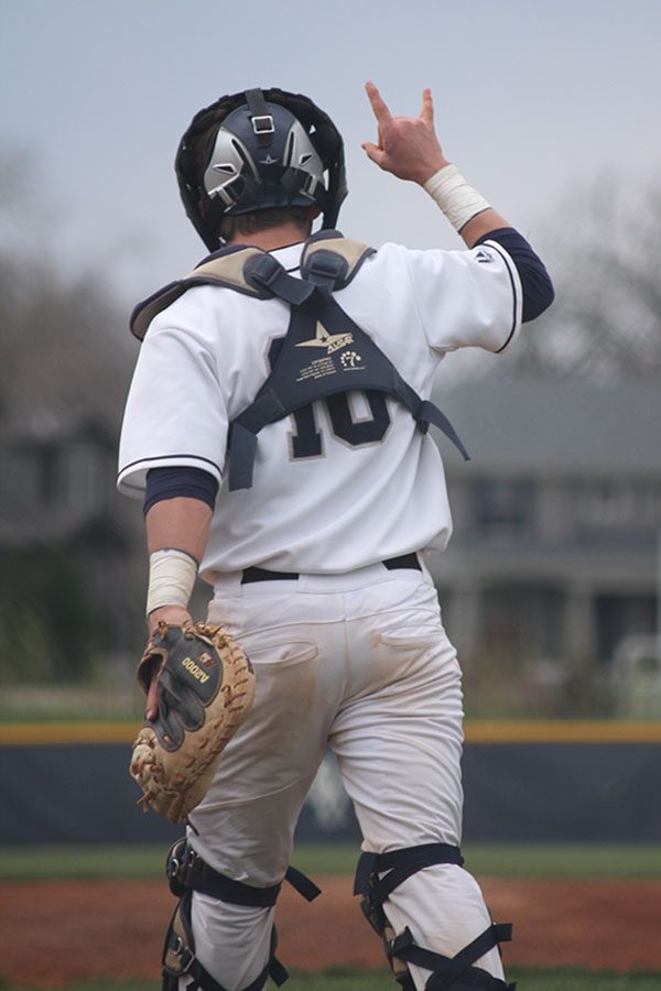 Raising his hand, junior Ethan Judd signals to the other players.