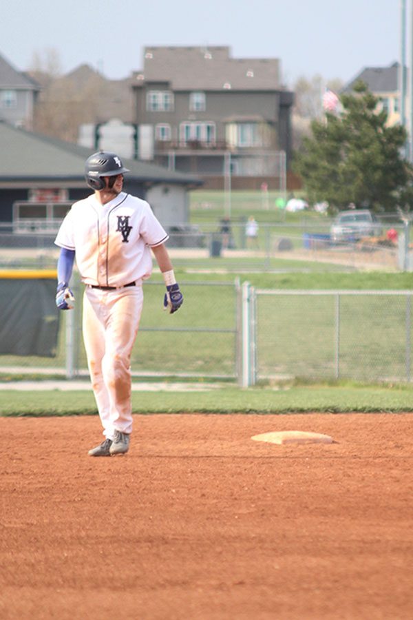 Assessing the positions of the opposing team, junior Quinton Hall attempts to steal third base.