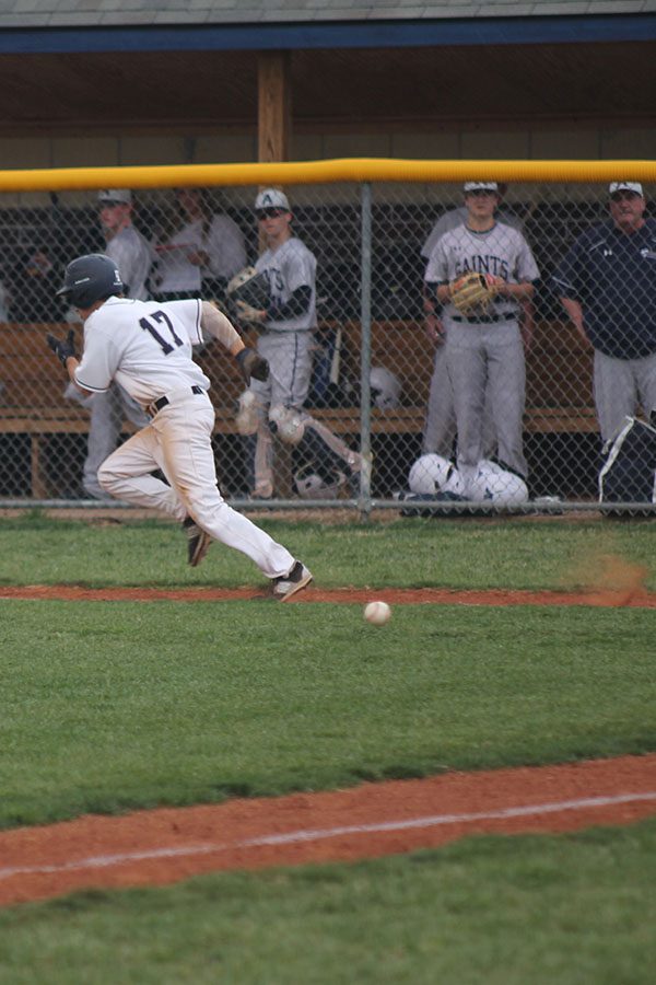 After bunting the ball, senior Will Morris races to first base.