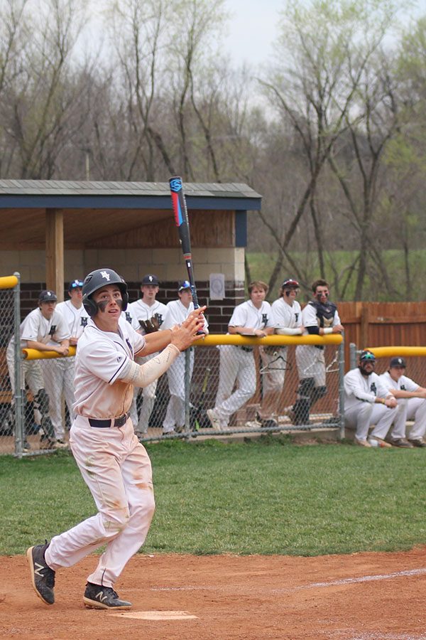 Looking towards the sky, senior Brayden Carr hits a foul ball.