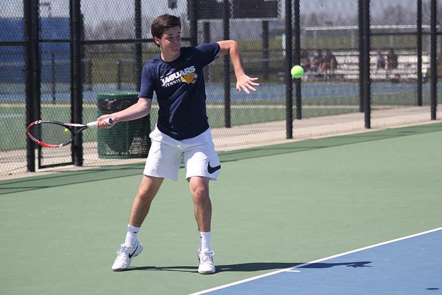 During the EKL tennis tournament on Saturday, April 28, sophomore Joey Gillette passes the ball to his opponent.
