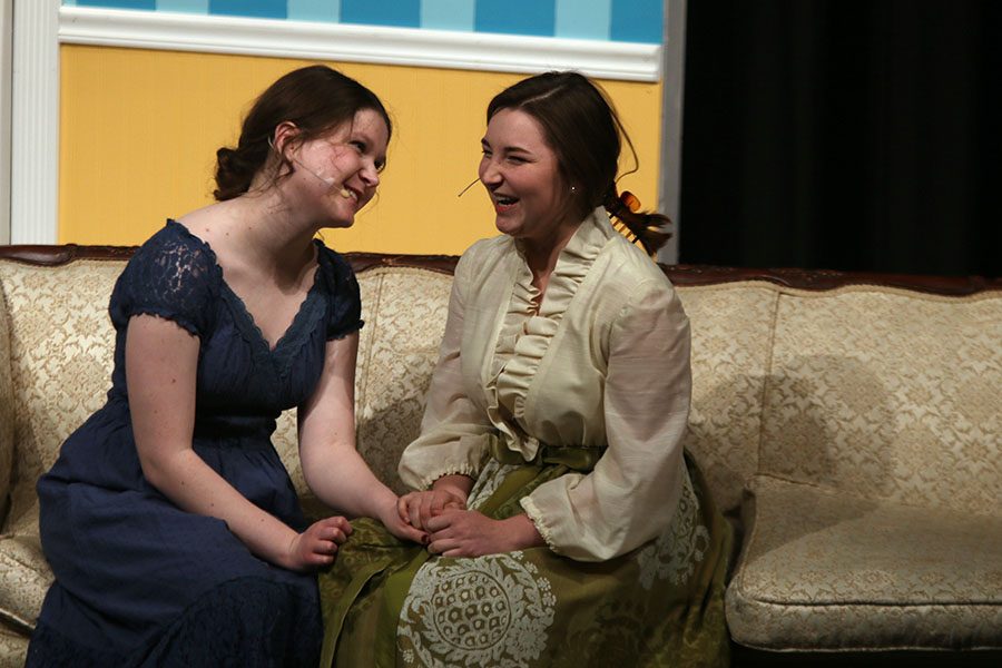 Elizabeth, played by senior Julia Feuerborn, laughs with Lydia, played by senior Kiley Beran.