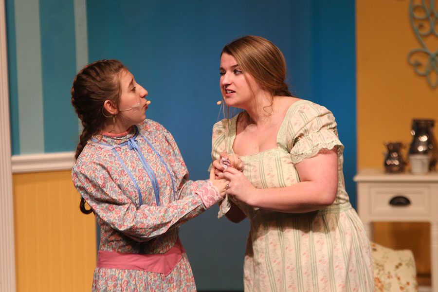 Mrs. Bennet, played by sophomore Ashley Grega, winks as she talks to Kitty, played by junior Jessie Coleman.