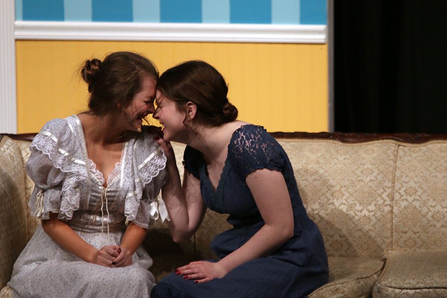 Jane, played by senior Natalie Cooper, laughs with her sister Elizabeth, played by senior Julia Feuerborn.