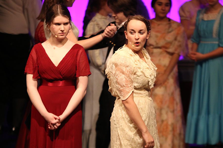 Louisa, played by junior Ashlyn Windmiller, speaks to Elizabeth, played by senior Julia Feuerborn, at a ball.