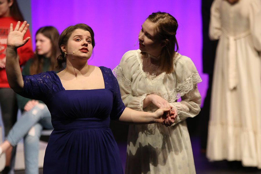 At a ball, Mrs. Bennet, played by junior Lindsey Edwards, converses with her sister Mrs. Phillips, played by senior Marissa Olin. 