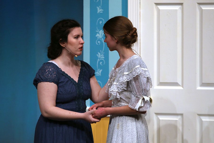 Elizabeth Bennet, played by senior Lauryn Hurley, informs her sister Jane, played by junior Annika Lehan, about Mr. Bingley.