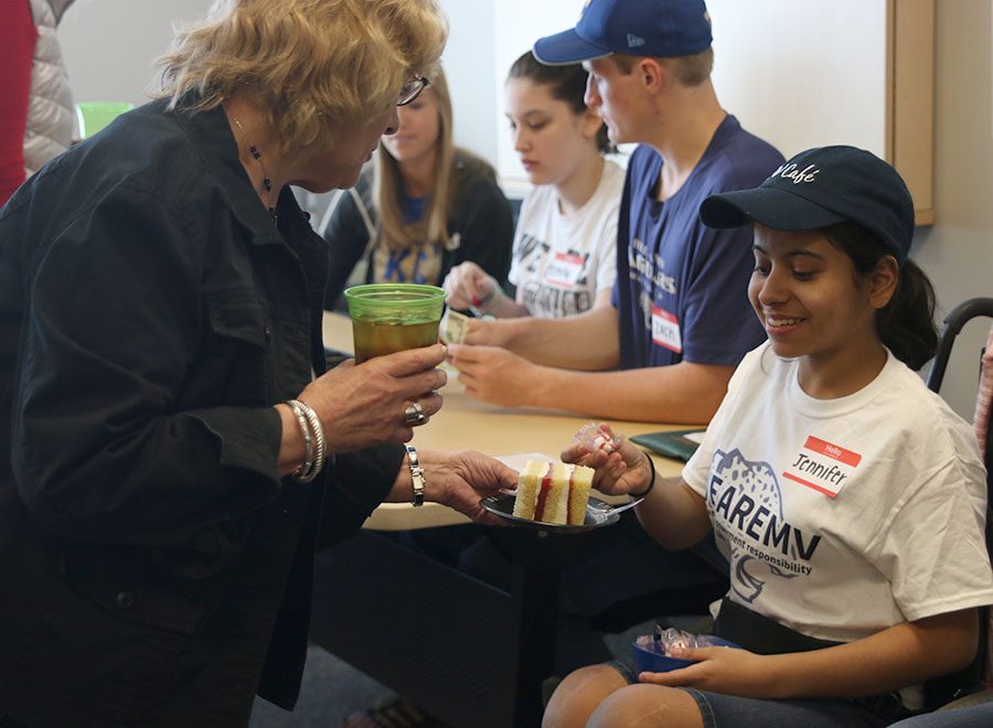 As customers finish their meals at the MV Cafe on Friday, April 27, freshman Jennifer Yanez hands them mints as they leave.