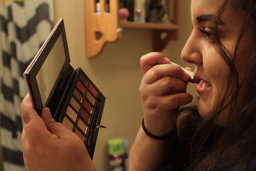 Before school on Tuesday, March 20, junior Claire Segura puts on lipstick along with the rest of her makeup. “Makeup gives me an extra boost of confidence and it’s really fun to play with and do fun looks,” Segura said.