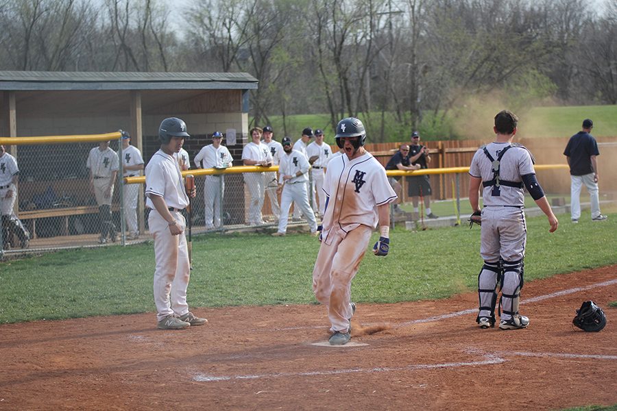 After an error was made by Aquinas, junior Quinton Hall celebrates his run on Tuesday, April 24. The team defeated Aquinas 7-3. Our team as a whole played fantastic, Hall said. [We] did the little things perfect and hit behind runners to get them over.