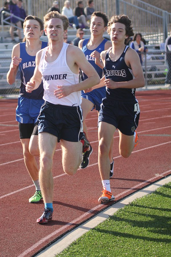 Moving through a pack, sophomore Anthony Pentola races the boys 1600 m. Pentola placed 10th.