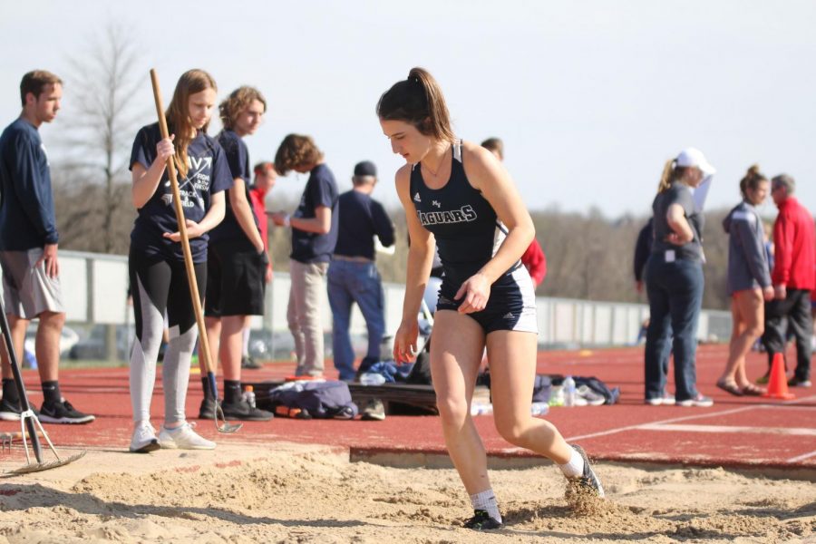 Sophomore Grace Hanson finishes her triple jump.