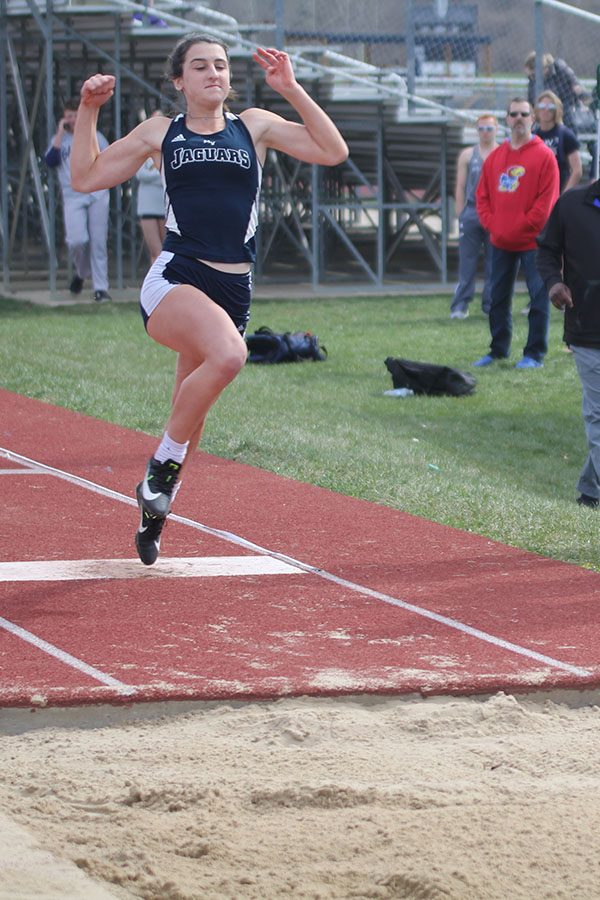 Sophomore Grace Hanson prepares to land during the girls triple jump, which she placed third. Junior Mya Johnston placed first and junior Erin Miller placed second.