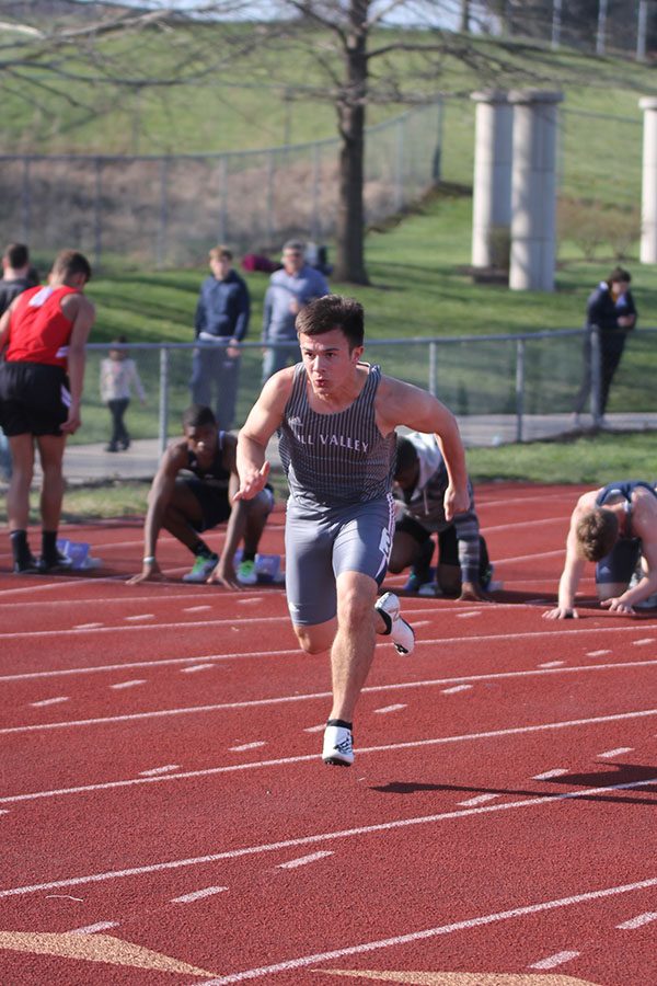 Junior Henry Lopez warms up before the boys 100 m. Junior Steven Colling placed third and Lopez placed seventh.