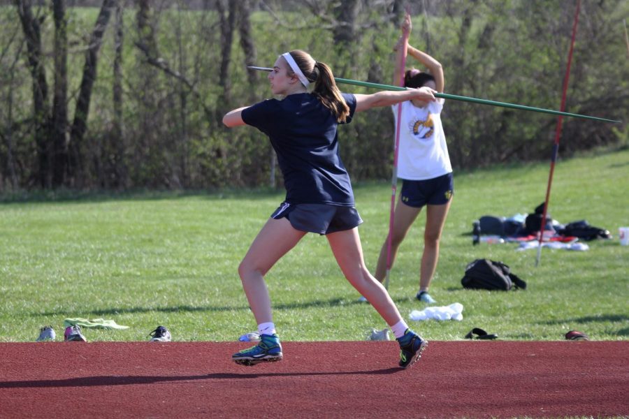 Running forward, senior Claire Boone prepares to throw her javelin on Tuesday, April 17.