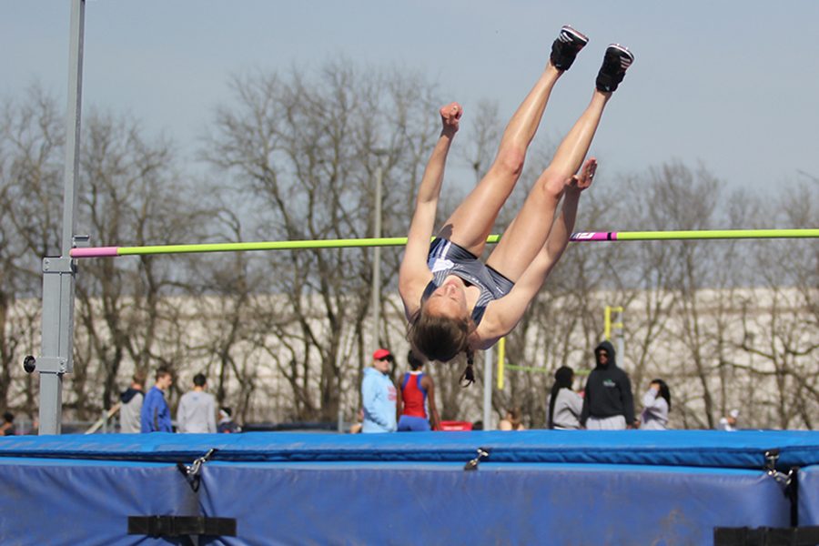 Sophomore Macy Thomas completes the high jump. Junior Erin Miller placed fifth and senior Evan Zars placed seventh.
