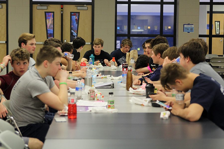 Following his morning workout at zero hour on Tuesday, April 17, junior Jayce Zukowski sits in the cafeteria with his football teammates to eat breakfast and work on homework. I [eat] whatever they are serving that morning, Zukowski said. I enjoy this routine because it wakes me up and gets my mind right for the day ahead.