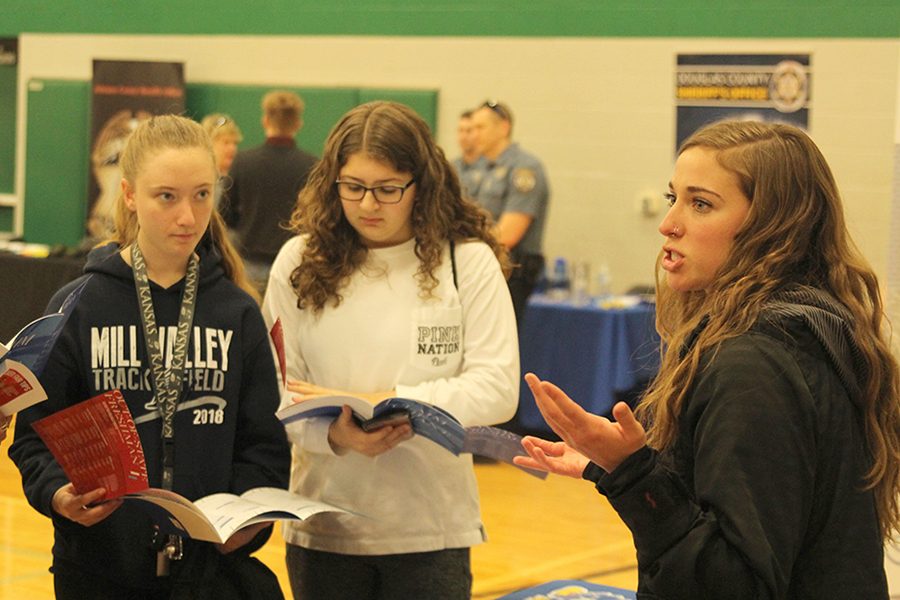 University of Kansas admissions officer Emily Hoffman explains the enrollment process to a group of Mill Valley students. I look at all the schools that are coming [to the career fair] and get a judgement of how many students are going to attend [University of Kansas], Hoffman said.