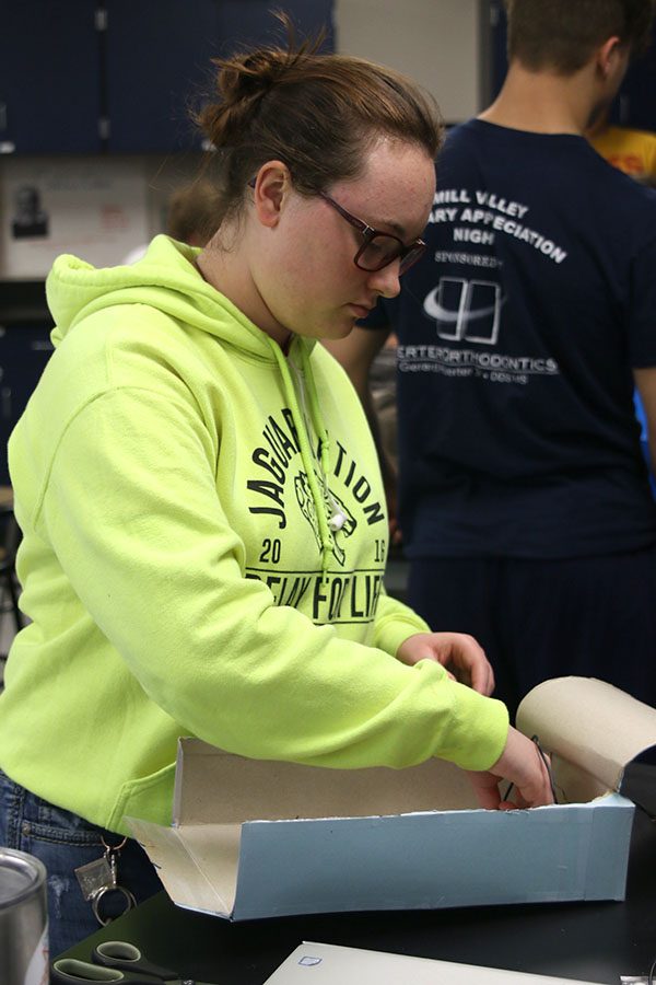 While rewiring her circuits, Rachel Kurovski alternates the color-coded wires.