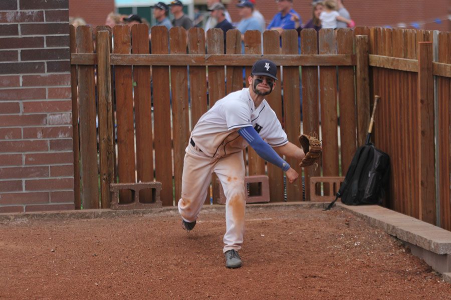 Warming up to play, junior Quinton Hall pitches the ball.