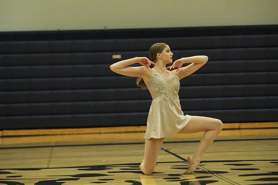 On Saturday, March 31, junior Addie Ward dances to Into the Dark in her solo routine at the Annual Silver Stars spring show. 