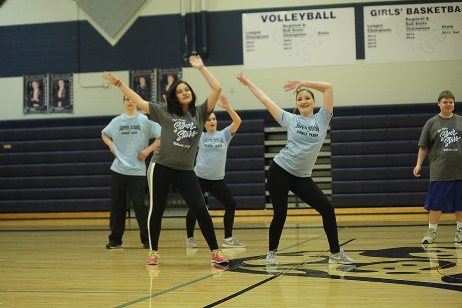 Senior Abby Sutton dances with senior Emily Wagner in the Super Stars routine.