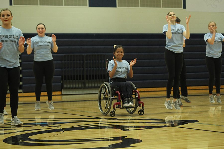 Sophomore Jennifer Yanez claps her hands during the Super Stars performance. 