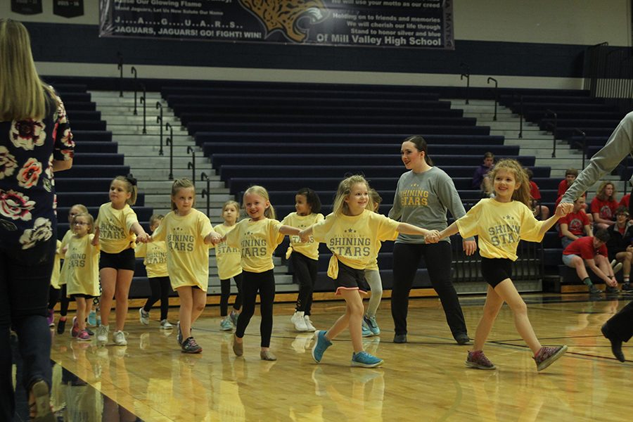 Junior Eve Steinle helps bring out the Shining Stars before their performance. 