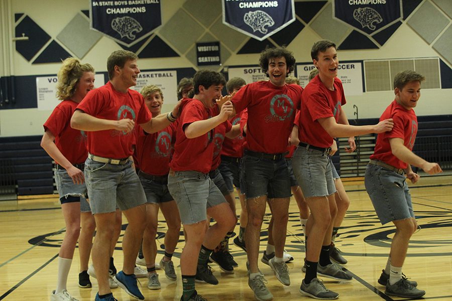 Jumping into the air, senior Simon Stewart performs in the Silver Stud performance. 