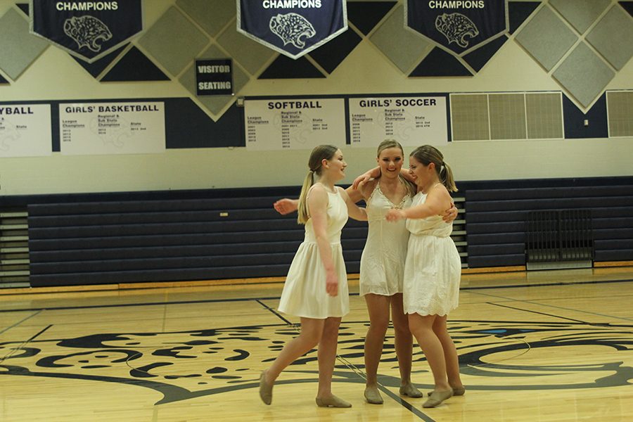Seniors Abby Sutton, Emmy Bidnick and Emma Barge hug at the end of the Silver Stars Seniors routine. 