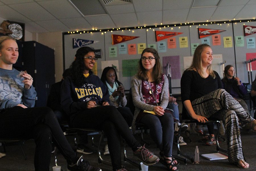 Sophomores Eva Burke and Callie Roberts talk with juniors Madelyn Lehn and Elizabeth Joseph while they wait patiently before the next performance. 