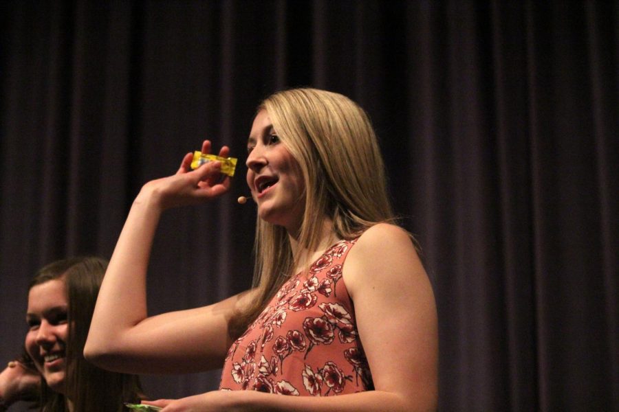 During a break in performances, junior Lexi Knappen tosses candy into the crowd.