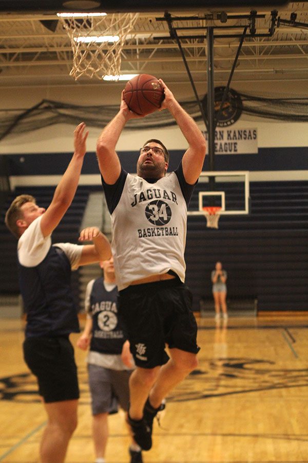 Jumping towards the basket, business teacher Kurt Bangle scores for the faculty team.