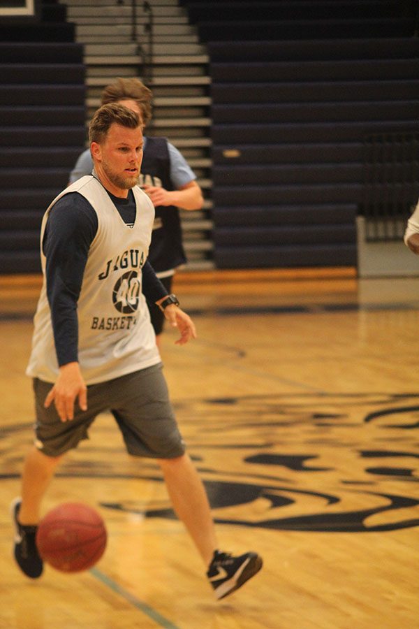 Dribbling down the court, paraprofessional Zach McFall plays at the annual student faculty basketball game on Tuesday, May 8.